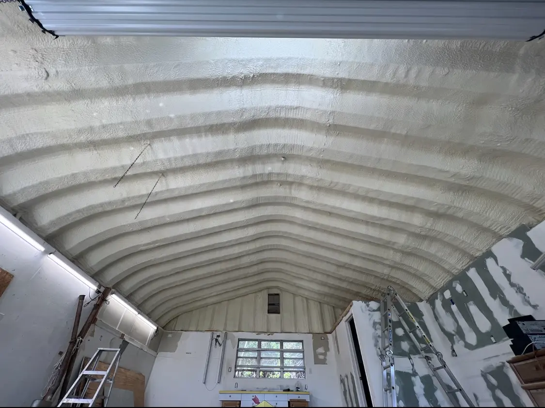 Spray polyurethane foam applied to the underside of a metal roof deck in Barnstead